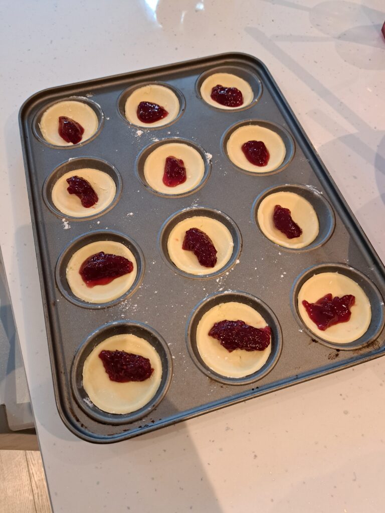 bun tray with jam on pastry